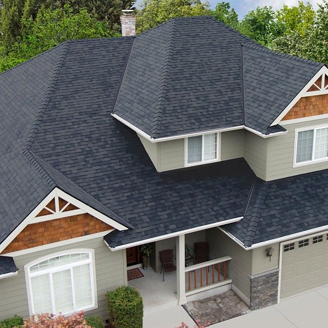 Aerial view of a completed charcoal architectural shingle roof with cedar gable accents